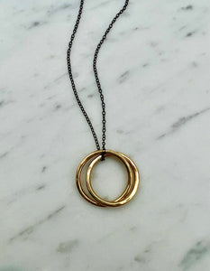 Interlocking Gold Circle Pendant on Black Silver Necklace