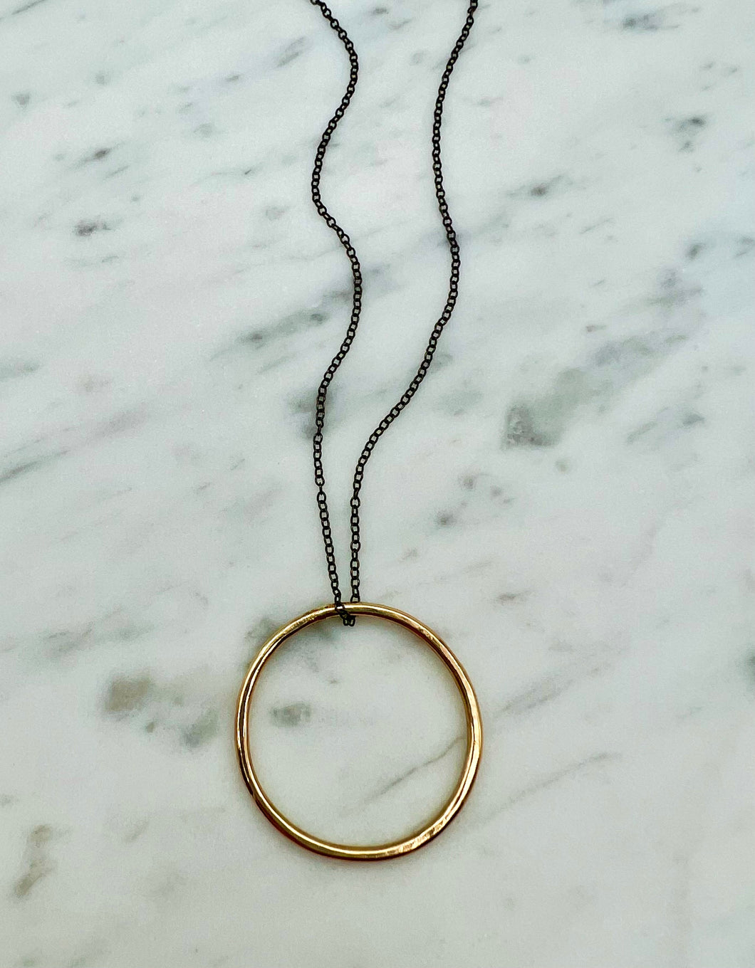 Large Gold Circle Pendant on Black Silver Necklace
